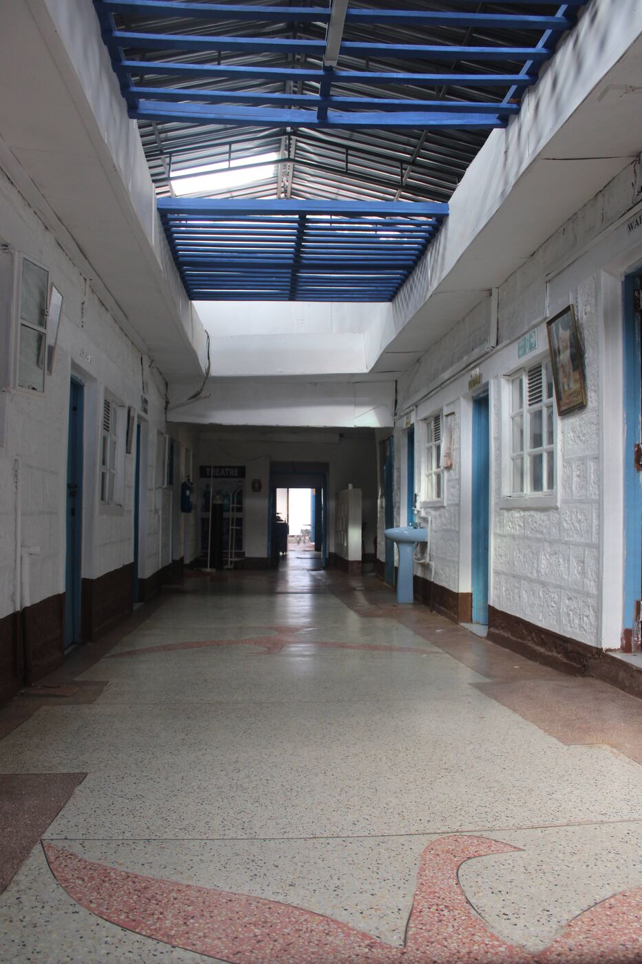 A bright skylit corridor connecting the wards