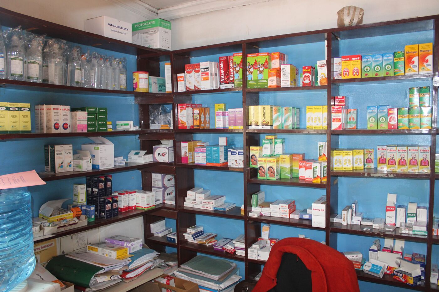 Pharmacy shelves stocked with medicines and healthcare essentials