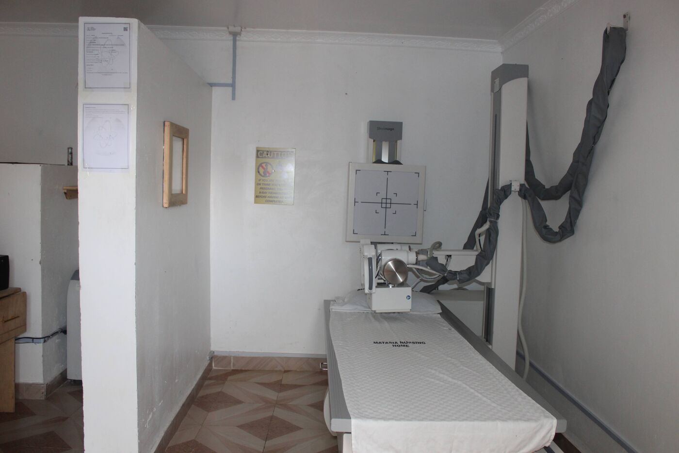 The X-ray room with its imaging table and wall-mounted detector